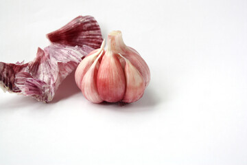 Head of fresh garlic close-up on a white background. Space for text. Concept - vitamins, plant benefits, vegetarianism.
