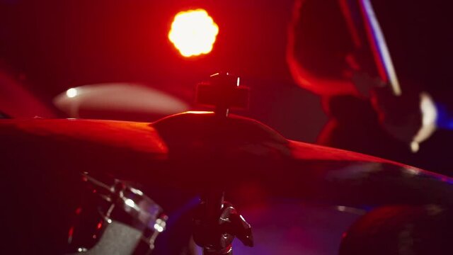 Drummer hits ride cymbal with sticks