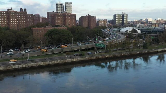 aerial tilt down with housing project and traffic on the Harlem River Drive in New York City