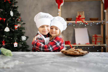 Children baker brother and sister made homemade Christmas cookies in the kitchen. A boy and a girl...