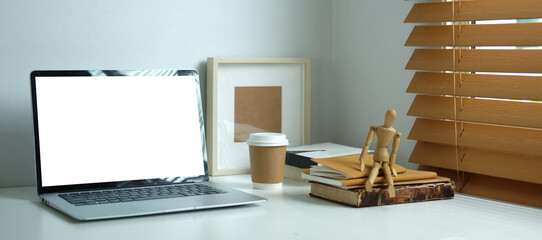 Creative workspace with blank screen on white table..