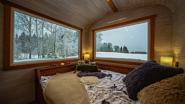 home interior bedroom decor. Thermowood chalet, winter landscape view through big windows