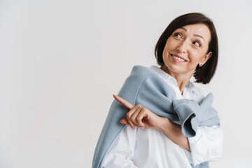 Fototapeta premium European mature woman smiling and pointing finger aside