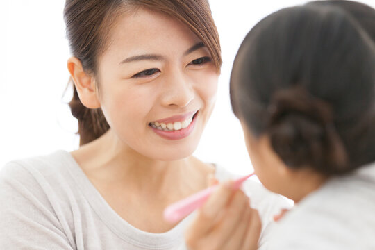 子供の歯磨きをする母親