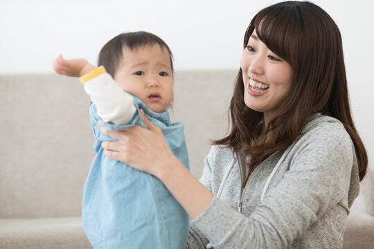 赤ちゃんを抱っこしようとする女性