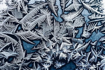 Frosty patterns on glass. Winter beautiful background.