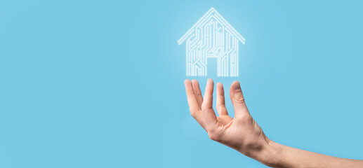 Naklejka premium Hand hold house icon.Smart home controlled, intelligent house, and home automation app concept.Pcb design and person with smart phone. Innovation technology internet Network Concept.