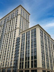 Fototapeta na wymiar Modern multi-storey building on blue sky background