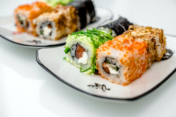 Several sushi on a white plate standing on a white background
