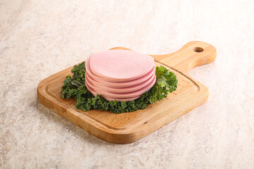 Slices pork sausage over board © Andrei Starostin