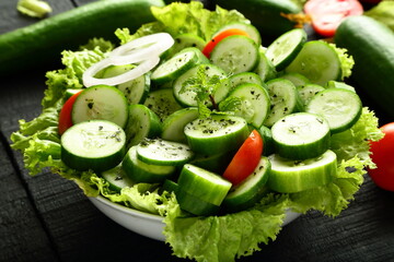 Bowl of fresh cucumber salad with  herbs and oil