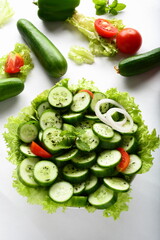 Bowl of fresh cucumber salad with  herbs and oil