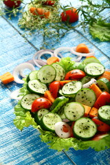 Delicious homemade mixed vegetable salad. with cucumber, onions, tomato and herbs.