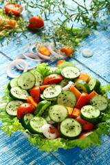 Delicious homemade mixed vegetable salad. with cucumber, onions, tomato and herbs.