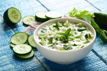 Bowl of delicious yogurt raitha salad with cucumber and onions.