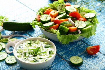 Healthy vegan diet meal, homemade delicious raitha, raita, salad with curd, yogurt, and  fresh greens. 