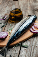 Atlantic mackerel fish on wooden background. Healthy food, diet or cooking concept. vertical image. top view