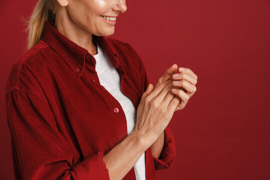 Mature Blonde Woman Wearing Shirt Smiling And Rubbing Her Hands