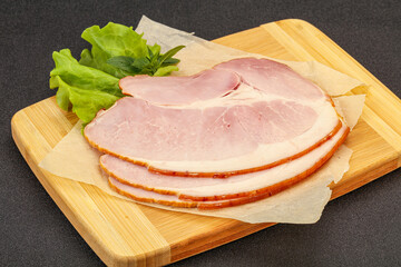 Sliced pork belly over board