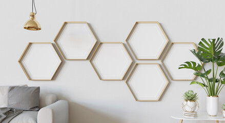 Gold hexagon blank photo frames mockup hanging on white interior wall. Hexagonal pictures in modern living room with wooden floor. 3D rendering