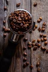 Fresh roasted coffee beans. Portafilter. Dark background.