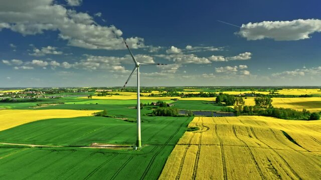 Wind turbine and rape fields in spring. Poland from above