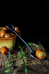 Fresh dates in a plate on a dark background, simple composition, rustic style