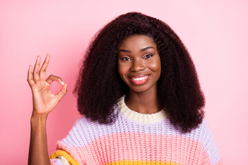 Portrait of positive dark skin lady toothy smile fingers show okey approve symbol isolated on pink color background