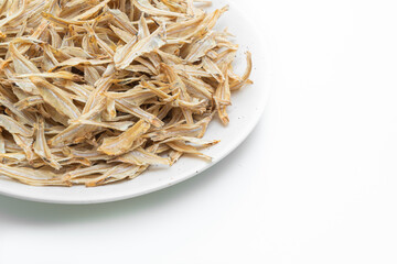 dried small crispy fish on white background