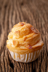almond cruffin with custard filling on rustic wood texture background, cruffin is hybrid of croissant and muffin
