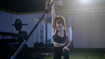 Fitness woman  exercise landmine press with barbell while kneel weightlifting