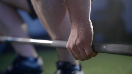 Man hands grip the barbell and deadlift close-up