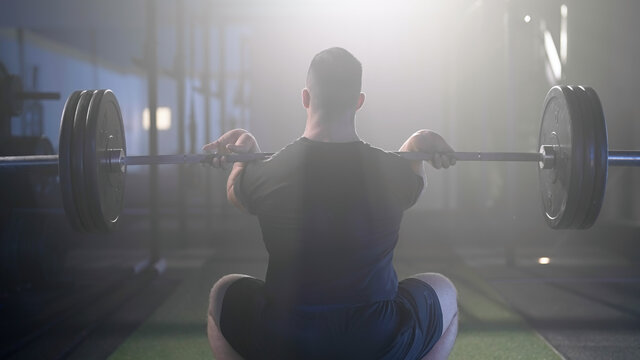 Man compete powerlift weightlifting under spotlight