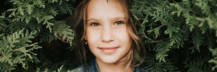 portrait of the face of a cute happy caucasian candid healthy eight year old kid girl surrounded by...