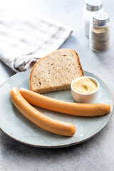 Smoked frankfurter sausages on plate.
