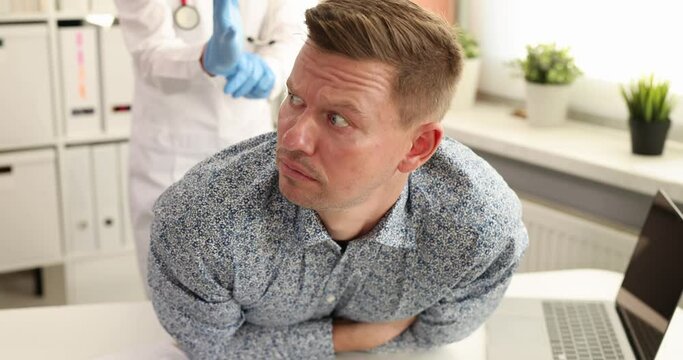 Doctor proctologist conducts medical examination of young male patient 4k movie