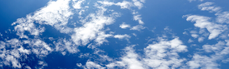 Panoramic photo of blurred sky. Blue sky background with cumulus clouds