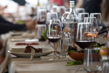 dining table inside the restaurant. people celebrating. Close-up wine glass