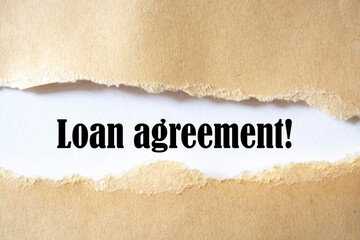 loan agreement. words. text on brown paper on torn paper background.