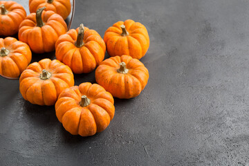 Orange decorative pumpkins with reflection in round mirror. Autumn and Halloween stylish home decor.