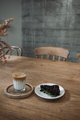 Latte art coffee on wooden table in coffee shop