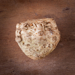 Fresh celeriac on a wooden board. Wooden background. Harvest concept. Top view.