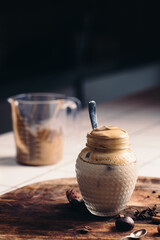 Homemade Dalgona coffee in a mason jar. DIY. Do it yourself in a kitchen.