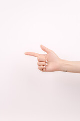 Scissors-shaped hand in front of the white background