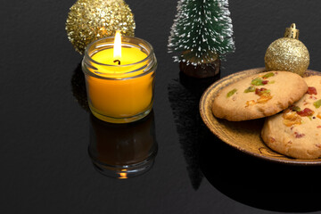 Christmas table decorations with orange peel cookies, miniature pine tree and a scented candle.