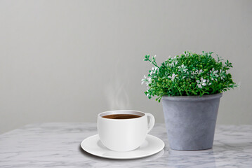 Hot coffee in white mug with tray Place on a marble table with flower pots placed on the sides and copy space. text area