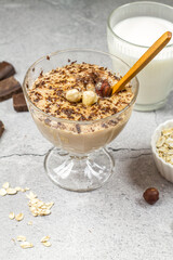 Caramel chocolate pudding on oat milk with chocolate and nuts