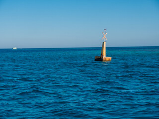Steel navigational floating buoy in the blue  sea water.