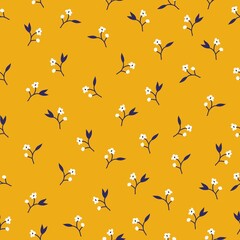 Cute pattern in small white flowers, black leaves. yellow background. seamless floral pattern. trend print is suitable for textiles and wallpaper.