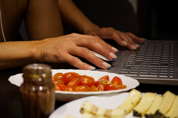 working from home. detail of hands on laptop keyboard.